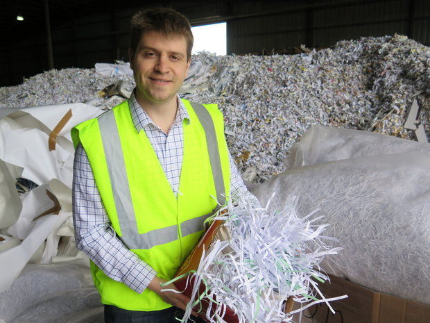 Aaron Goodman, chief operations officer at Northstar Pulp & Paper in Springfield, shows a sample of paper that the company will accept in its new cash-for-paper program targeting the general public. (Judith Kelliher)